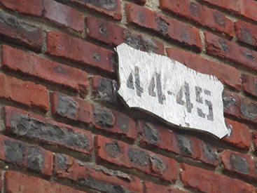 Zoomed in shot of 44-45 sign on brick building