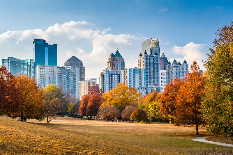 Colorful trees of Piedmont Park with skyscrapers of Atlanta seen in the background