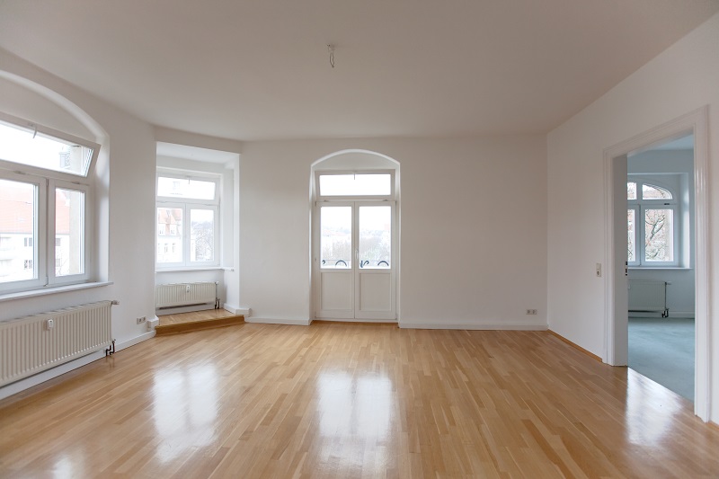 Interior of empty apartment with wood floors and white paint job