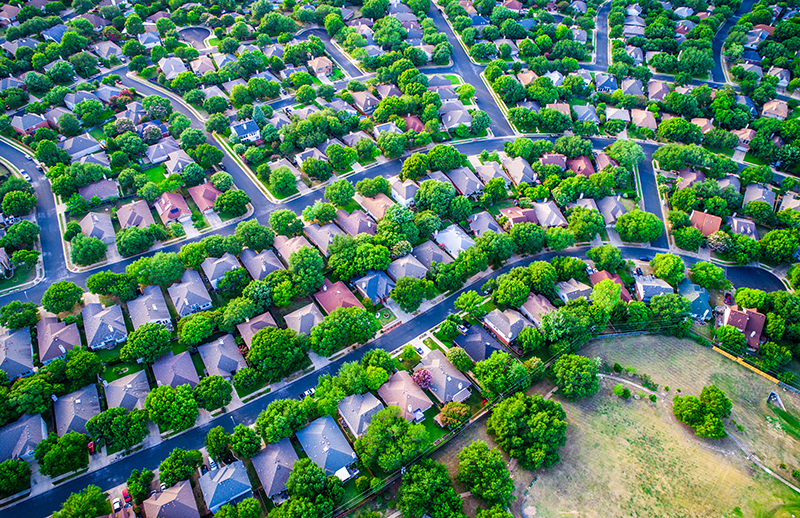 Overhead shot of tree-filled suburban neighborhood