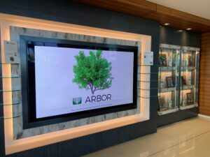 A digital display showing a tree with the Arbor Realty Trust logo.