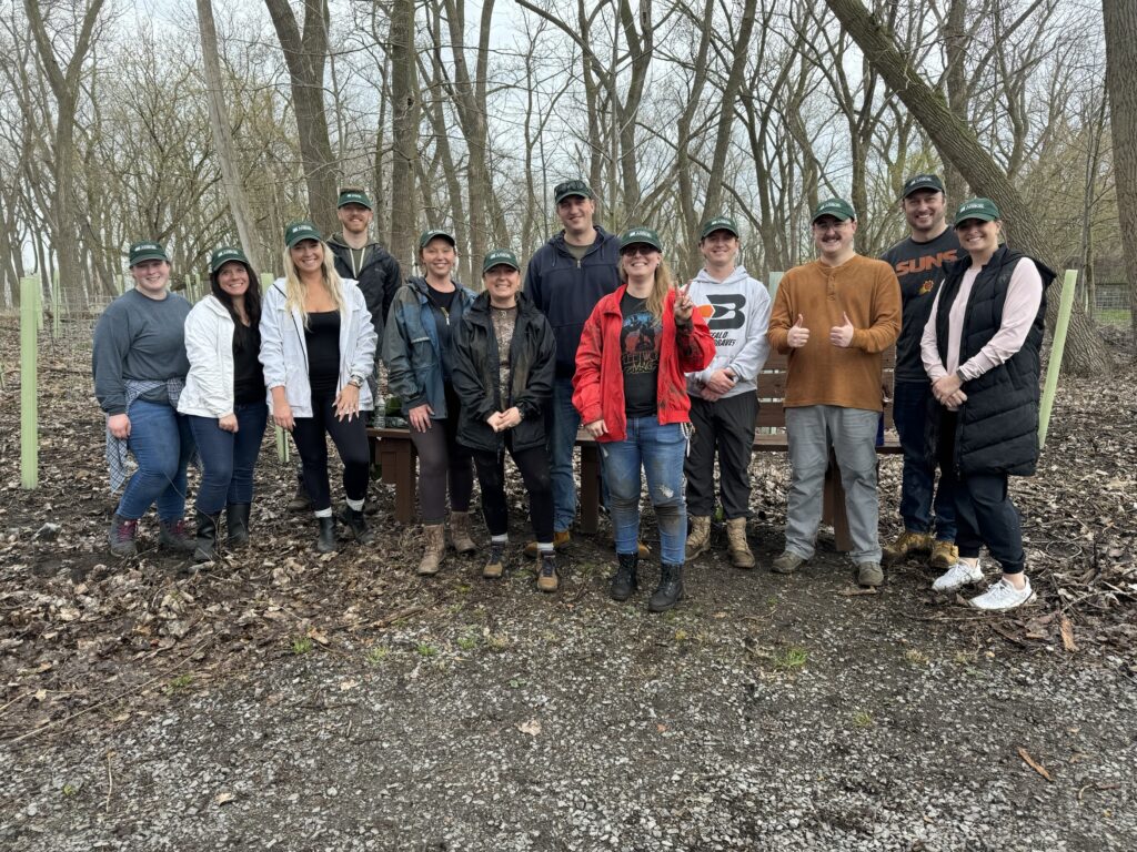 A group photo of Arbor employees at a tree planting at Tifft Nature Preserve in Buffalo.