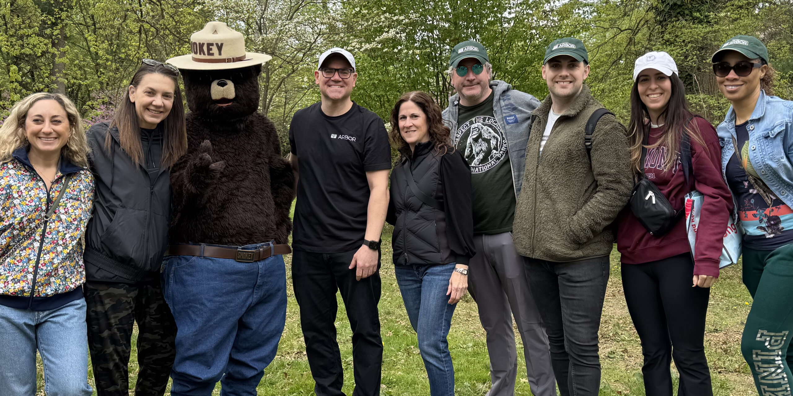 A group of Arbor Realty Trust employees with Smokey Bear at a tree planting